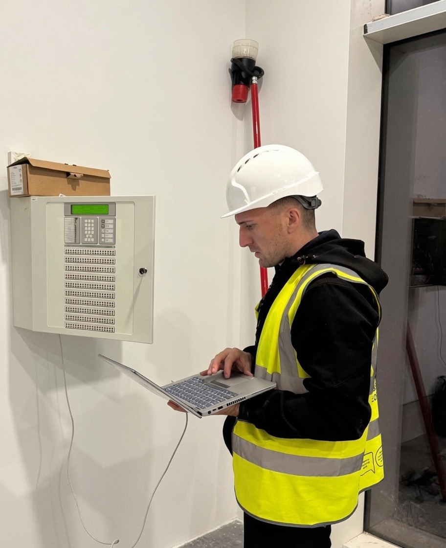 Vanguard engineer commissioning a fire alarm control panel